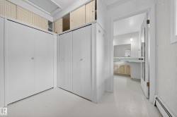 White interior featuring built-in white closet doors and overhead storage - 