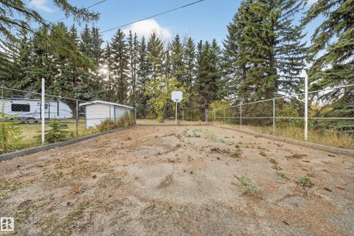 Fenced outdoor court area featuring a basketball hoop - 707 65 Avenue, Edmonton, AB 