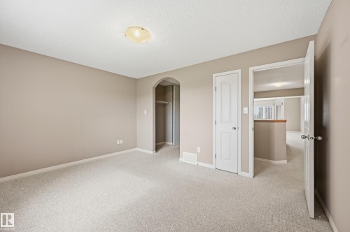 Neutral-toned wall finishes with white trim and carpeting throughout - 7460 Singer Landing, Edmonton, AB 