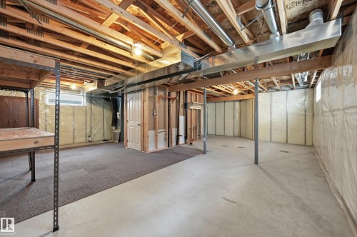 Unfinished basement offering exposed ceiling joists, concrete flooring, and partial carpet flooring - 7460 Singer Landing, Edmonton, AB 