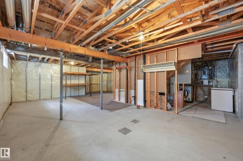 Unfinished basement with exposed ceiling joists and support beams - 7460 Singer Landing, Edmonton, AB 