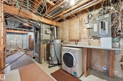 Unfinished basement area featuring exposed ceiling joists and utilities - 7460 Singer Landing, Edmonton, AB 