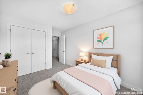 Bedroom featuring neutral wall colors, textured carpeting, and a built-in closet with double doors - 2433 Glenridding Boulevard, Edmonton, AB 