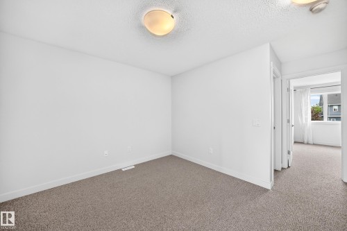 Spacious room featuring neutral carpeting and white wall paint - 2433 Glenridding Boulevard, Edmonton, AB 