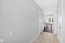 Entryway featuring light tile flooring and crisp white trim - 2433 Glenridding Boulevard, Edmonton, AB 