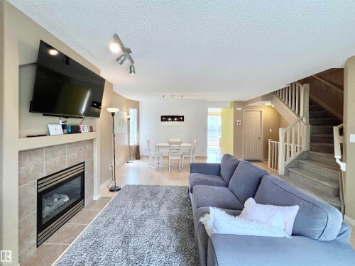 8 4755 Terwillegar Common, Edmonton, AB - Indoor Photo Showing Living Room With Fireplace
