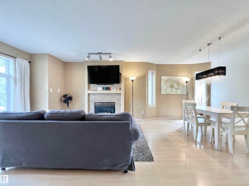 8 4755 Terwillegar Common, Edmonton, AB - Indoor Photo Showing Living Room With Fireplace