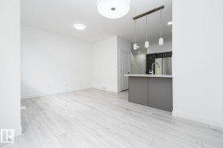 Open-concept living area featuring light wood-finish flooring, recessed lighting, and a modern island with an integrated sink - 