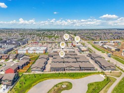 Aerial perspective showcasing residential developments, commercial structures, and extensive open green spaces - 