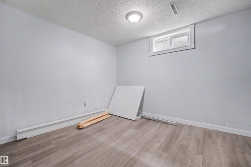Room with wood-finish flooring, light gray walls, and white trim - 12707 87 Street, Edmonton, AB 