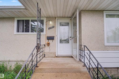Front entry with concrete stairs and black metal railings - 12707 87 Street, Edmonton, AB 
