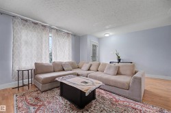 Living area featuring wood-finish flooring and light blue walls - 