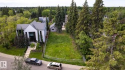 Spacious undeveloped lot featuring mature surrounding trees and a gentle slope - 