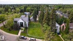 Expansive vacant lot featuring natural ground cover, mature surrounding trees, and a clear boundary - 