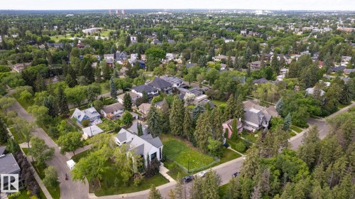 Aerial perspective showcasing a residential area with varied architectural styles, mature trees, and a developed street grid - 14307 Summit Drive Nw, Edmonton, AB 