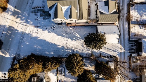 Expansive lot featuring a large open area, mature tree, and surrounding residential structures - 14307 Summit Drive, Edmonton, AB 