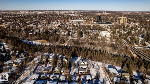 Aerial perspective of a sprawling urban landscape featuring a dense forest buffer - 14307 Summit Drive, Edmonton, AB 
