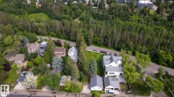 Aerial perspective showcasing multiple properties nestled amidst extensive mature tree coverage - 