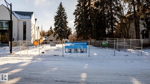 Cleared land parcel featuring metal fencing and surrounding mature trees - 14307 Summit Drive, Edmonton, AB 