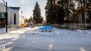 Cleared land parcel featuring metal fencing and surrounding mature trees - 14307 Summit Drive, Edmonton, AB 