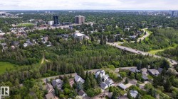Aerial perspective showcasing residential properties amidst extensive mature tree coverage - 