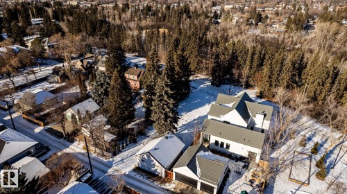 Modern white exterior with multiple gables and a metal roof - 14307 Summit Drive, Edmonton, AB 