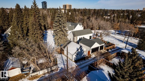 Modern exterior featuring white siding and a dark-grey gable roof - 14307 Summit Drive, Edmonton, AB 