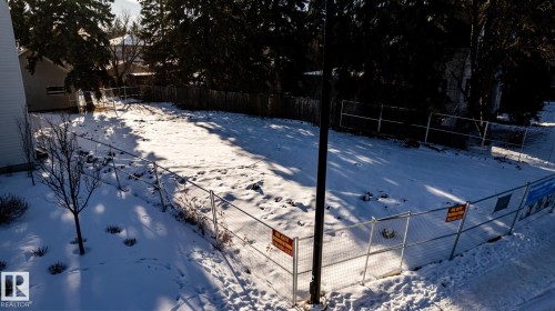 Vacant lot featuring perimeter fencing, mature trees, and a clear building envelope - 14307 Summit Drive, Edmonton, AB 