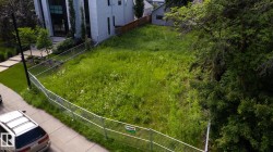 Expansive undeveloped lot with existing chain-link perimeter fencing - 