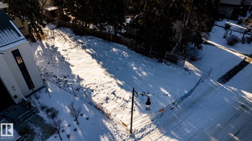 Expansive lot featuring a partial perimeter fence and a sidewalk border - 14307 Summit Drive, Edmonton, AB 