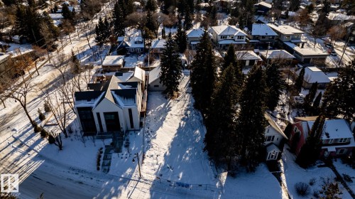 Contemporary residence featuring a striking gabled roofline and a light-toned facade - 14307 Summit Drive, Edmonton, AB 