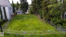 Expansive lot featuring mature perimeter trees, a chain-link fence, and a level grassy expanse - 14307 Summit Drive Nw, Edmonton, AB 