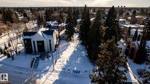 Modern architectural home featuring a striking facade, multiple large windows, and a tiered front walkway - 14307 Summit Drive, Edmonton, AB 