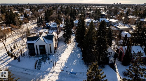 Modern architecture featuring a gabled roofline, dark-framed windows, and a paved front walkway - 14307 Summit Drive, Edmonton, AB 