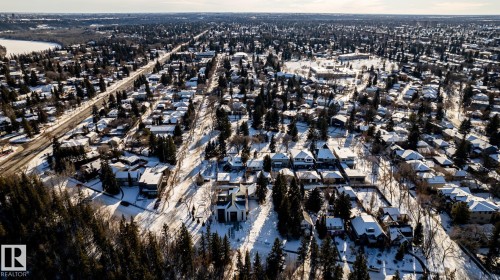 Aerial perspective showcasing a residential area with snow-covered rooftops and mature trees - 14307 Summit Drive, Edmonton, AB 