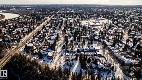 Aerial perspective of a sprawling residential area featuring a dense arrangement of homes and mature trees - 14307 Summit Drive, Edmonton, AB 