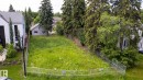 Cleared lot featuring perimeter fencing, mature trees, and a streetlamp - 14307 Summit Drive Nw, Edmonton, AB 