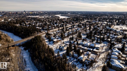 Aerial perspective of a sprawling residential area featuring a dense tree canopy and snow-dusted rooftops - 14307 Summit Drive, Edmonton, AB 