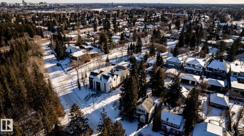 Residential area with varied architectural styles, mature tree canopy, and snow-covered ground - 14307 Summit Drive, Edmonton, AB 