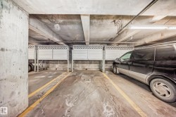 Covered parking space featuring concrete flooring and overhead lighting - 