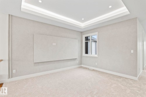 Tray ceiling with recessed lighting and cove lighting, wall-mounted electrical outlets, white trim, and light-colored carpeting - 13111 187 Avenue Nw, Edmonton, AB - Indoor Photo Showing Other Room