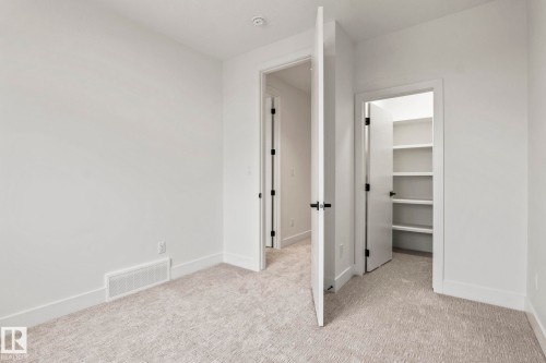 Neutral-toned carpeting, white walls, and white trim - 13111 187 Avenue Nw, Edmonton, AB - Indoor Photo Showing Other Room