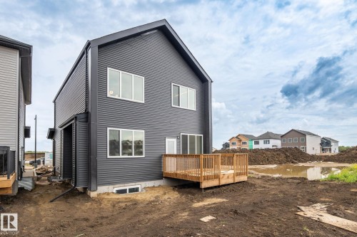Two-story exterior with dark horizontal siding, featuring multiple windows - 13111 187 Avenue Nw, Edmonton, AB - Outdoor With Exterior