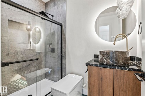 Glass-enclosed shower with a built-in bench, dark tile surround, and a rain showerhead - 13111 187 Avenue Nw, Edmonton, AB - Indoor Photo Showing Bathroom
