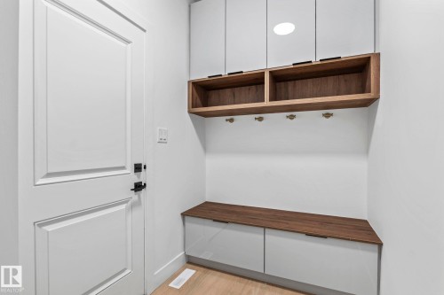Built-in bench with wood-finish top and integrated storage - 13111 187 Avenue Nw, Edmonton, AB - Indoor Photo Showing Other Room