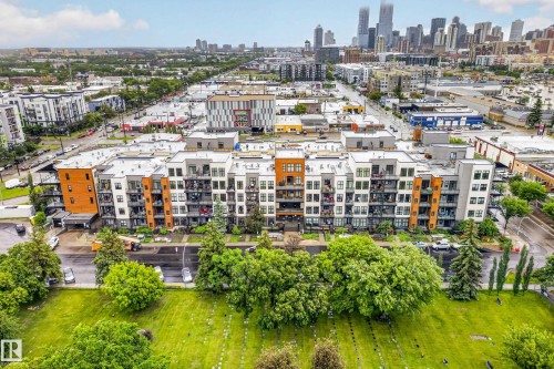 Modern multi-story building featuring a facade with varied paneling, private balconies, and an urban backdrop - 410 10531 117 Street, Edmonton, AB 