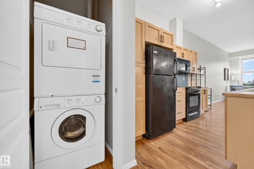 Dedicated laundry closet featuring a stacked washer and dryer - 410 10531 117 Street, Edmonton, AB 