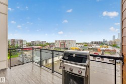 Balcony featuring wood-finish flooring and black framed glass railings - 