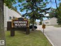 "Ormsby Manor" property signage with wood construction and carved detailing - 6348 180St, Edmonton, AB 
