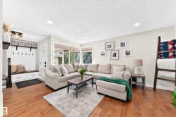 Living area featuring warm wood-finish flooring and recessed lighting - 